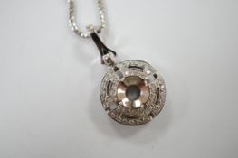 A modern pierced 18k white metal and diamond chip cluster set circular pendant, overall 29mm,