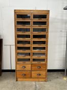 A mid century oak twenty drawer haberdashery cabinet, width 91cm, depth 49cm, height 198cm.