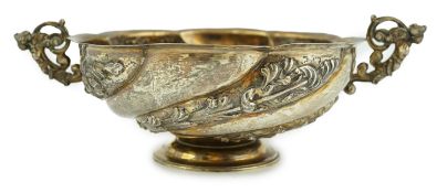 A late Victorian repousse silver two handled fruit bowl, by Charles Stuart Harris, on pedestal foot,
