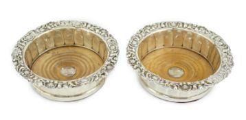 A pair of George III silver mounted wine coasters, by John & Thomas Settle Gunn & Co, of panelled