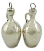 A pair of Victorian silver single handled ovoid water/wine jugs with stoppers, by R & S Garrard &