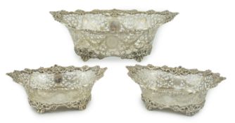 A graduated suite of three George V pierced silver oval bowls, by Charles Stuart Harris & Sons,