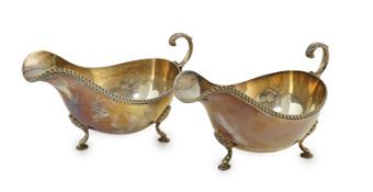 A pair of Elizabeth II silver sauce boats, by Barker Brothers Silver Ltd, with flying scroll