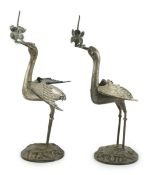 A pair of early to mid 20th century Japanese silver candlesticks, modelled as cranes, with
