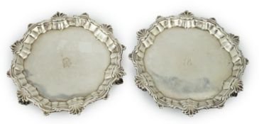 A pair of George II silver waiters, by William Peaston, with engraved initial, on three hoof feet (