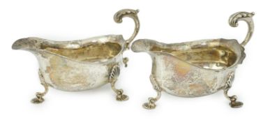 A pair of George V silver sauceboats, by Harrod's Ltd, with flying scroll handles, London, 1914,
