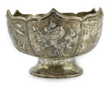 A Japanese white metal small rose bowl, decorated with panels of bamboo, birds and flowers, diameter