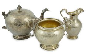 A Victorian Scottish silver three piece tea set, by Marshall & Sons, of ovoid form with engraved