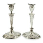 A pair of late Victorian silver oval candlesticks by Goldsmiths & Silversmiths (Gibson & Langman),