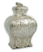 A late 19th century Hanau embossed silver bombÃ© shaped tea caddy and cover, with panels of fete