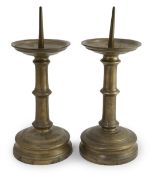 A pair of 16th century bell metal pricket candlesticks