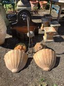 A bronzed metal stork garden ornament, a pair of terracotta lion mask wall appliqués and a pair of