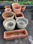 A group of twelve terracotta garden pots and planters and a pair of reconstituted stone garden