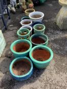 A collection of assorted glazed pottery garden pots and ornaments, largest diameter 42cm.