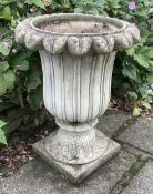A pair of reconstituted stone tulip urns, height 66cm, depth 50cm, planting removed. Condition -