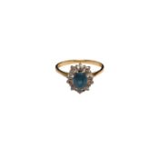 A modern 18ct gold, blue topaz and diamond set oval cluster ring, size M, gross weight 3.5 grams.
