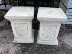 A pair of Sparta Statues reconstituted stone plinths, with scrolling foliate decoration, width 36cm,