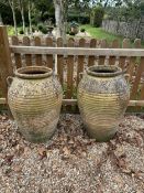 A pair of Italian style terracotta urns, height 75cm, width 48cm. Condition - weathered, otherwise