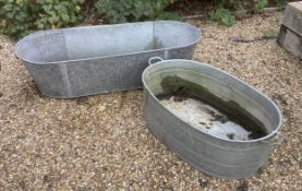 Two galvanised baths / tubs, 136cm and 104cm, planting removed, Condition - weathered otherwise