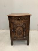 A Tudor style carved oak bedside cupboard, width 47cm, height 71cm. Condition - good