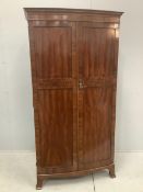 An Edwardian inlaid mahogany bowfront wardrobe, Maple & Co label, width 96cm, depth 53cm, height