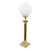 A tall brass Corinthian column table lamp with spherical glass shade, 84cm high including glass