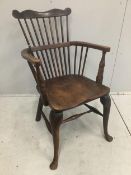 An early 18th century ash and elm primitive Windsor elbow chair on cabriole front legs, width