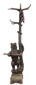 A late 19th/early 20th century Swiss 'Black Forest' carved wood hall stand, with rearing bear at the