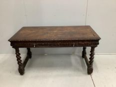 An early 20th century carved oak two drawer writing table, width 133cm, depth 67cm, height 72cm.