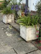 A pair of square reconstituted stone planters, width 50cm, height 49cm, planting removed.