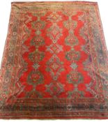 A large Turkish carpet, with triple row of stylised medallions on a red ground, multi bordered,
