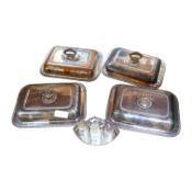 A set of four silver plated entrée dishes and covers and a plated four piece condiment stand,