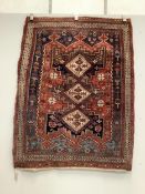 A Caucasian red ground rug, 150 x 118cm. Condition - worn in centre and a little faded, further wear