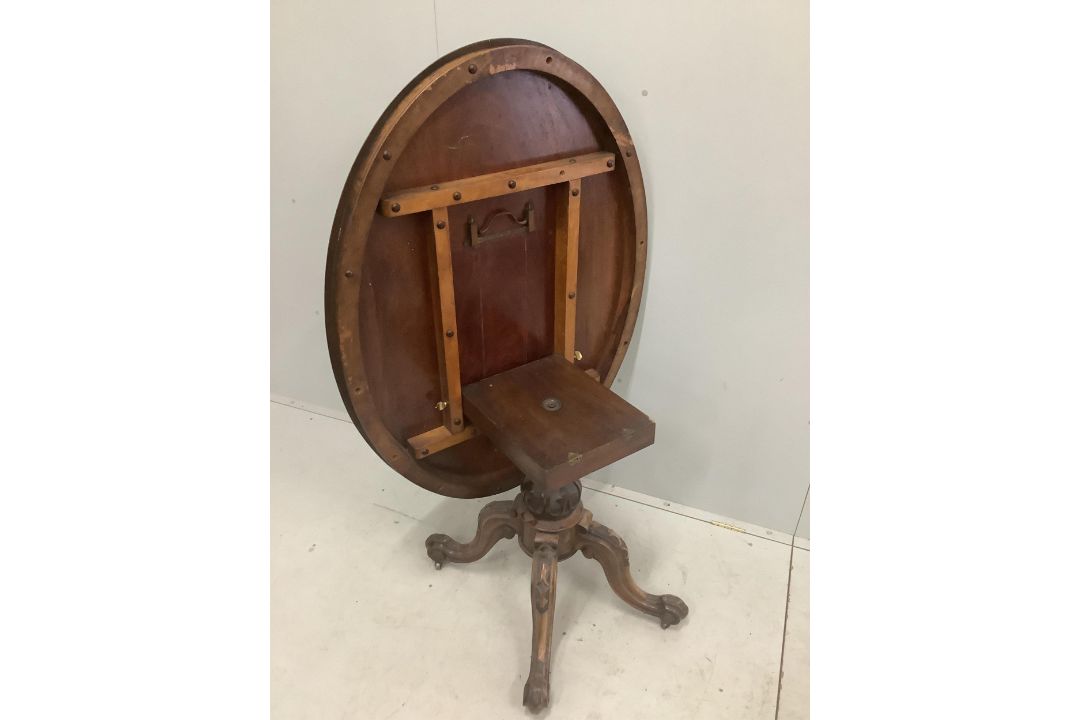 A Victorian carved walnut oval tilt top breakfast table, 120 x 92cm, height 72cm. Condition - fair - Image 3 of 3