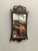 A George III style parcel gilt mahogany fret cut wall mirror, width 44cm, height 86cm. Condition -