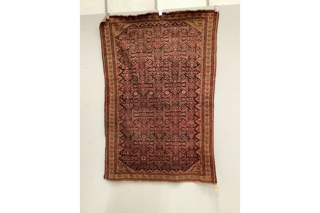 A Caucasian red ground rug, 192 x 129cm. Condition - faded and worn - Image 1 of 3