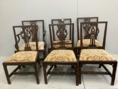 A set of six George III mahogany blind fret carved dining chairs, one with arms. Condition - poor to