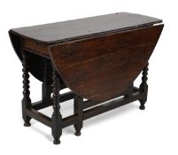 A 17th century and later oak gateleg table, with oval drop leaf top and single frieze drawer, on