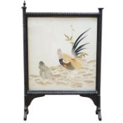 A Victorian fire screen inset with a Japanese cream silk embroidered panel of a cockerel, hen and