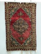 A North West Persian red ground rug, 170 x 106cm. Condition - faded and worn at the fringes