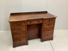 A Victorian mahogany kneehole desk, fitted nine small drawers, width 125cm, height 78cm. Condition -