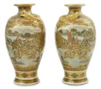 A pair of Japanese Satsuma 'dragon' vases, Meiji period, each painted with samurai, ladies and rakan