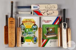 A collection of nine miniature cricket bats
