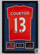 An orange Thibaut Courtois No.13 Chelsea football shirt