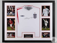 A white Umbro England shirt signed by Wayne Rooney