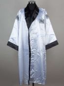 A white Everlast boxing robe signed by Joe Frazier.