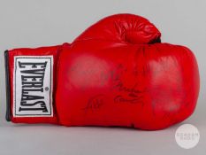 A red autographed Everlast boxing glove, autographed by nine boxers.