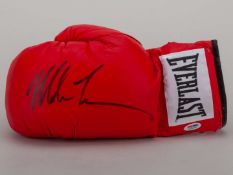 A red Everlast box glove signed by Mike Tyson.