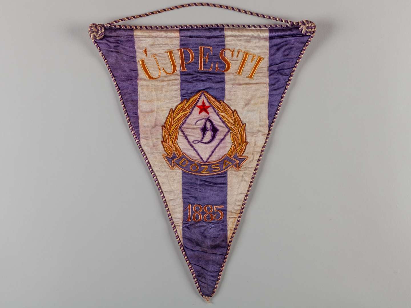 A purple and white Ujpesti Dozsa match pennant