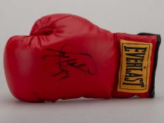 A red Everlast boxing glove signed by Larry Holmes.